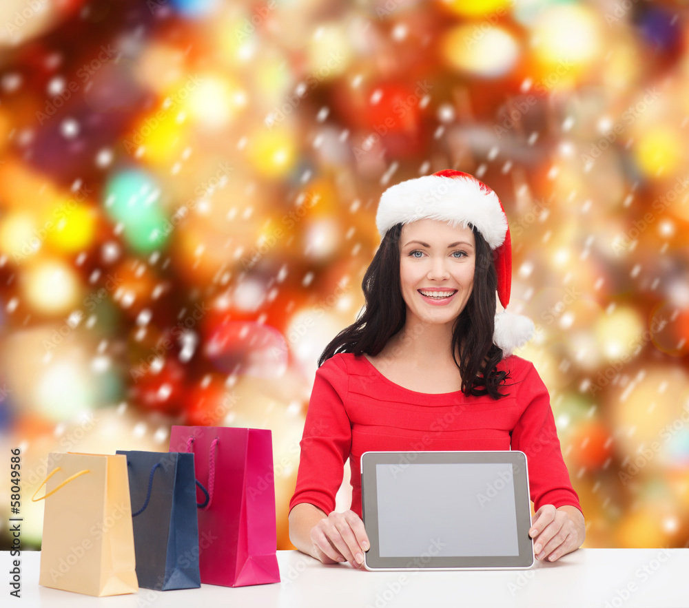 smiling woman in santa helper hat with tablet pc smiling woman in santa helper hat with tablet pc