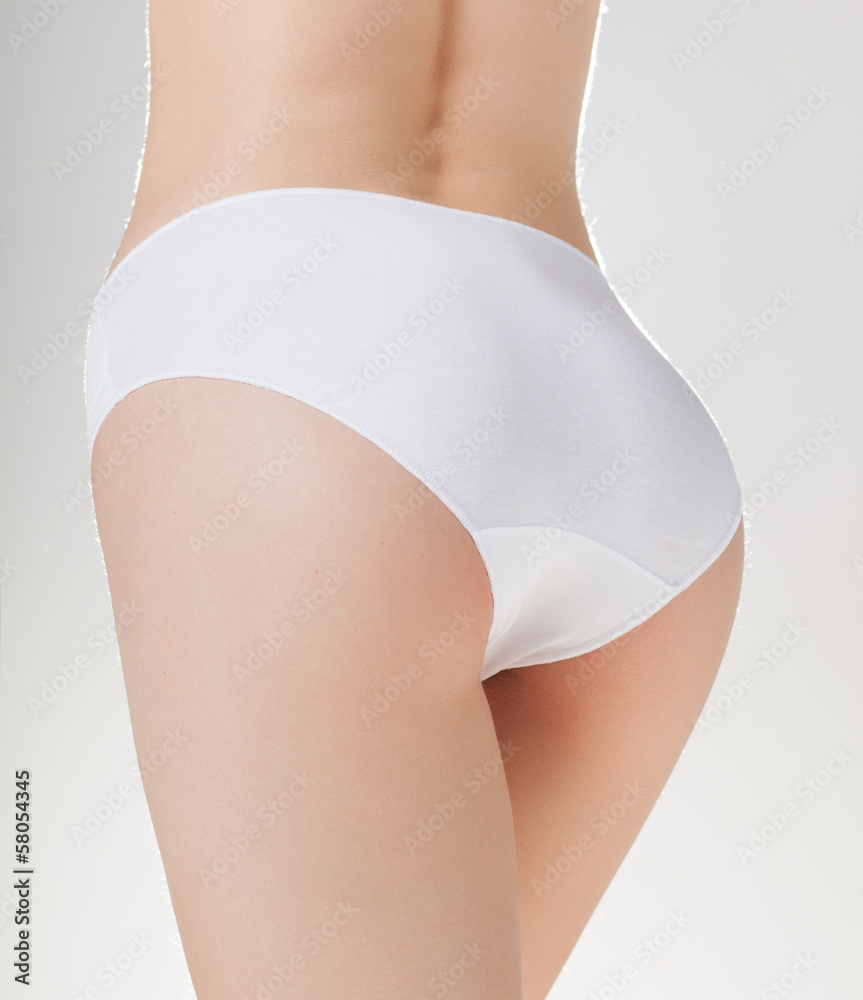 Foto de Beautiful fit woman booty in white panties do Stock