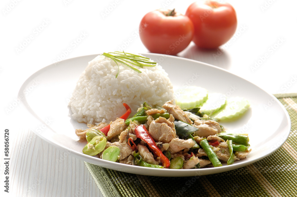 Chicken with rice and vegetables in background Chicken with rice and vegetables in background