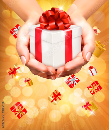 Holiday background with hands holding gift boxes. Concept of giv