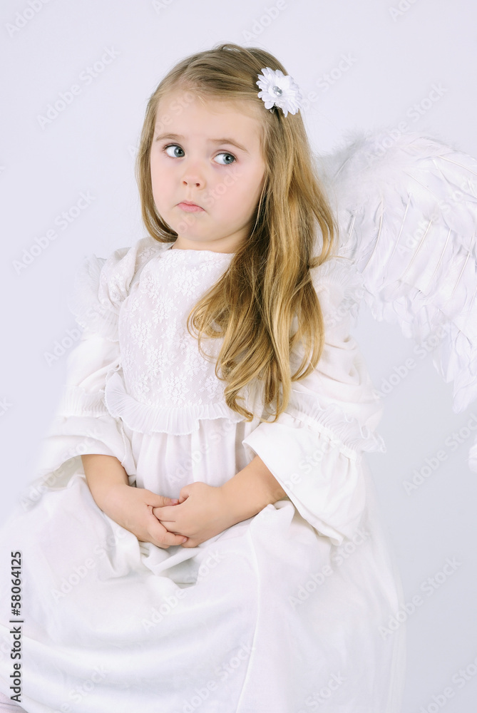A beautiful little girl angel with a book A beautiful little girl angel with a book