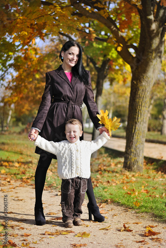 little boy with his mother in autumn park