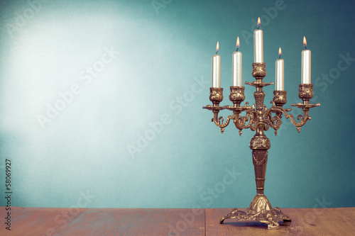 Vintage bronze candlestick with five burning candles photo