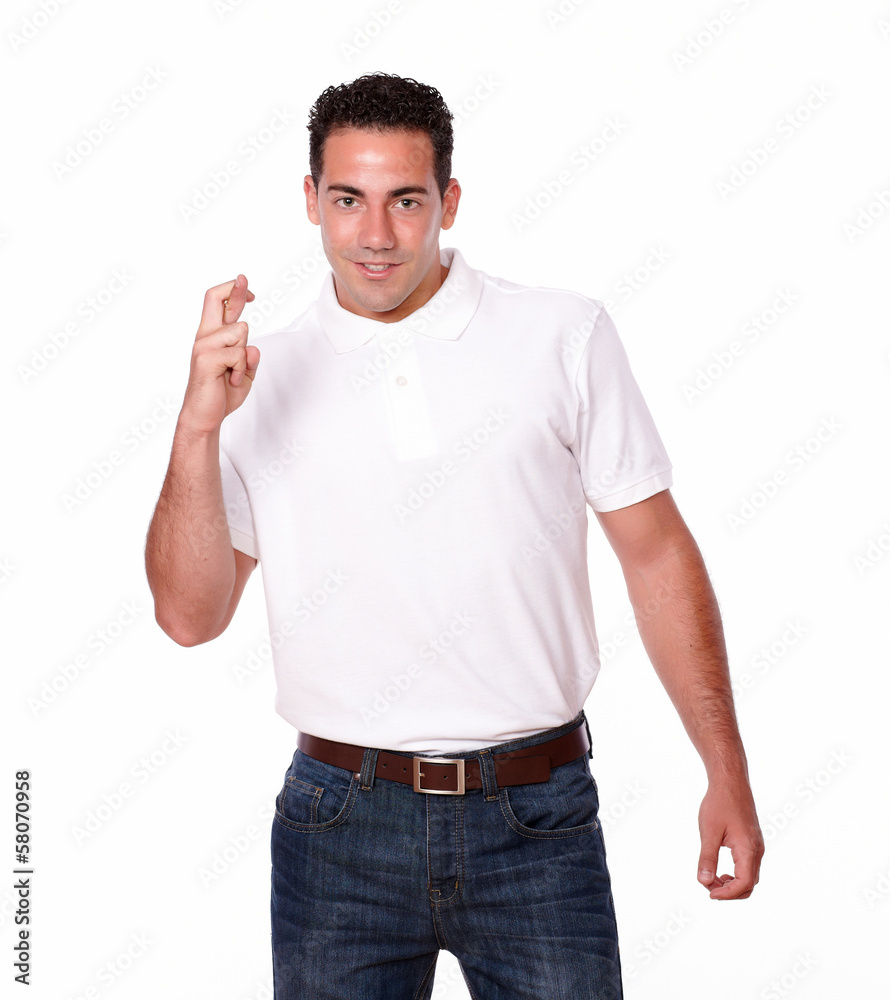 Charming man smiling and crossing fingers Charming man smiling and crossing fingers