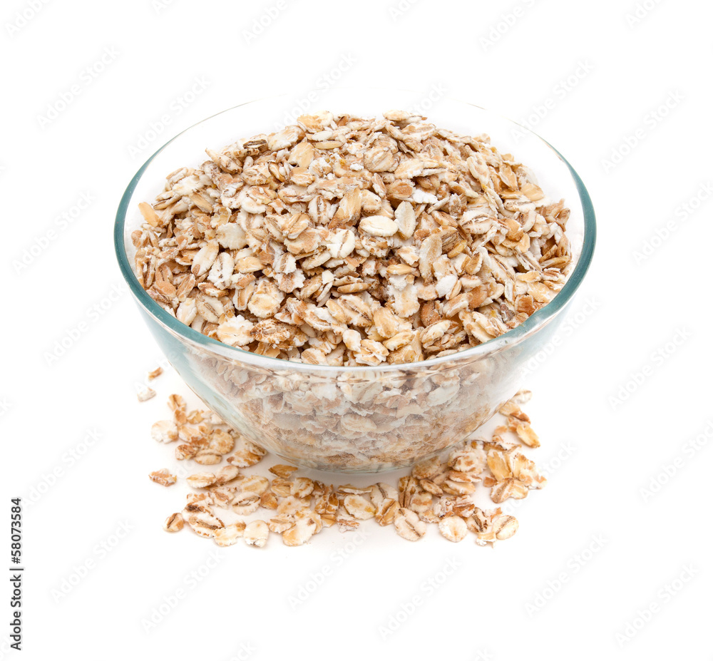 oat flakes in a glass bowl isolated on white oat flakes in a glass bowl isolated on white