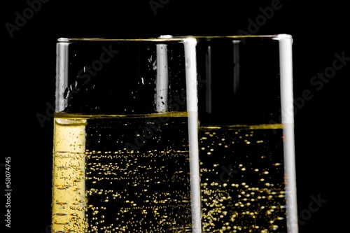 detail of a pair of flutes of champagne with golden bubbles