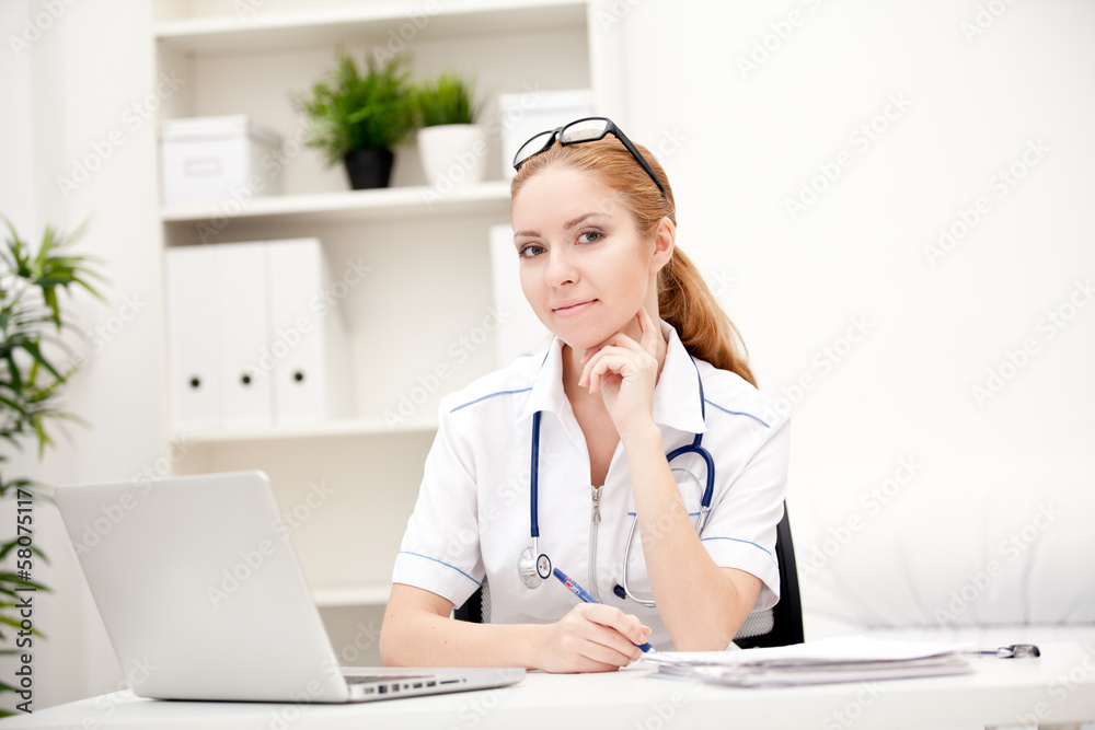 Portrait of a smiling physician working in her office Portrait of a smiling physician working in her office