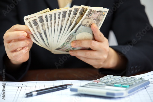 Hand counting money, Japanese currency note , Japanese yen photo