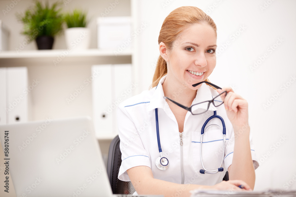 Portrait of a smiling physician working in her office Portrait of a smiling physician working in her office