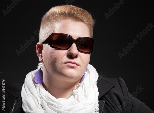 Portrait of Chubby woman with short hair and sunglasses © leszekglasner