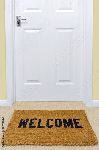 Bild auf Leinwand Welcome doormat outside a door.