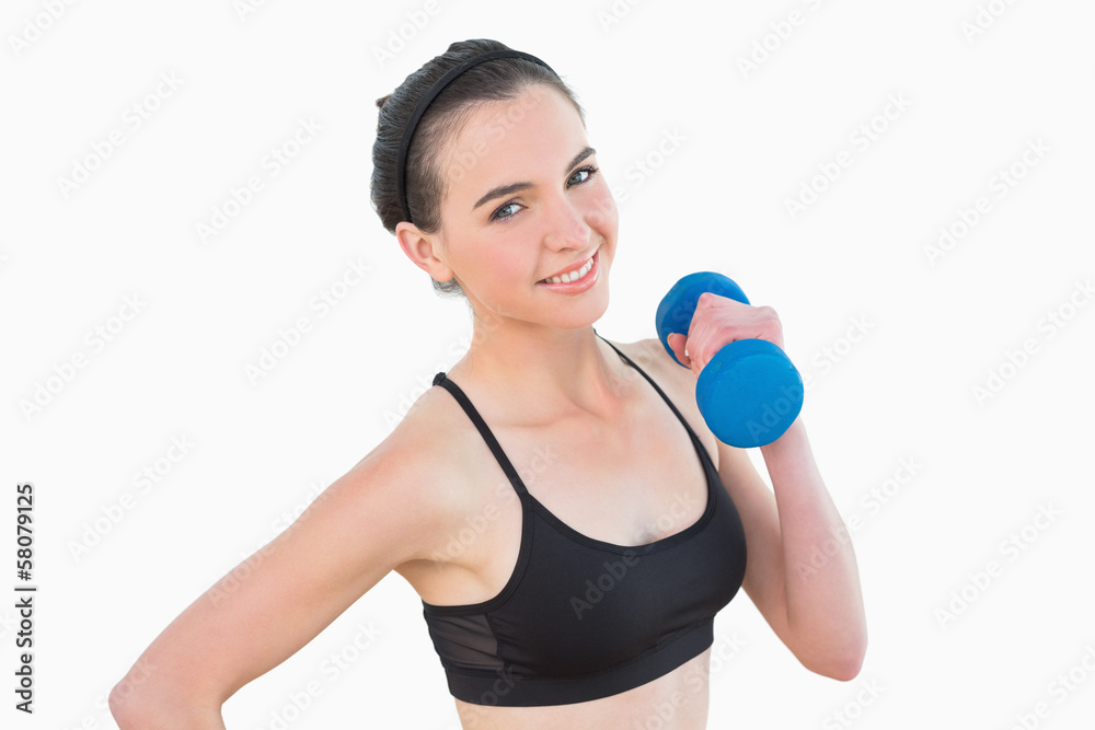 Portrait of a smiling young woman with dumbbell Portrait of a smiling young woman with dumbbell