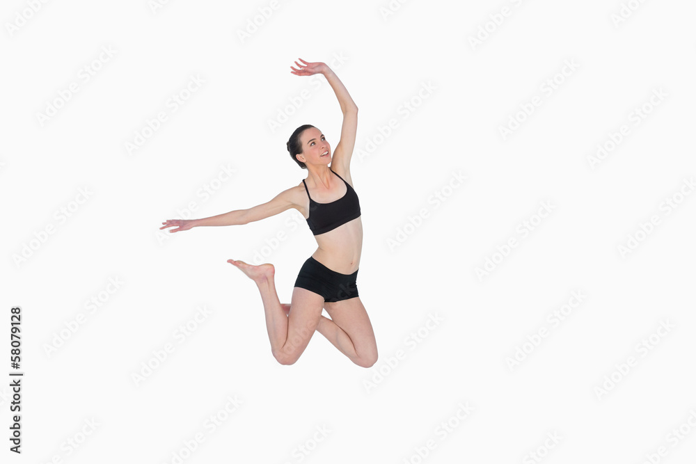 Full length of a sporty young woman jumping Full length of a sporty young woman jumping