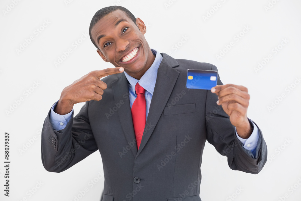 Cheerful young Afro businessman pointing at credit card Cheerful young Afro businessman pointing at credit card