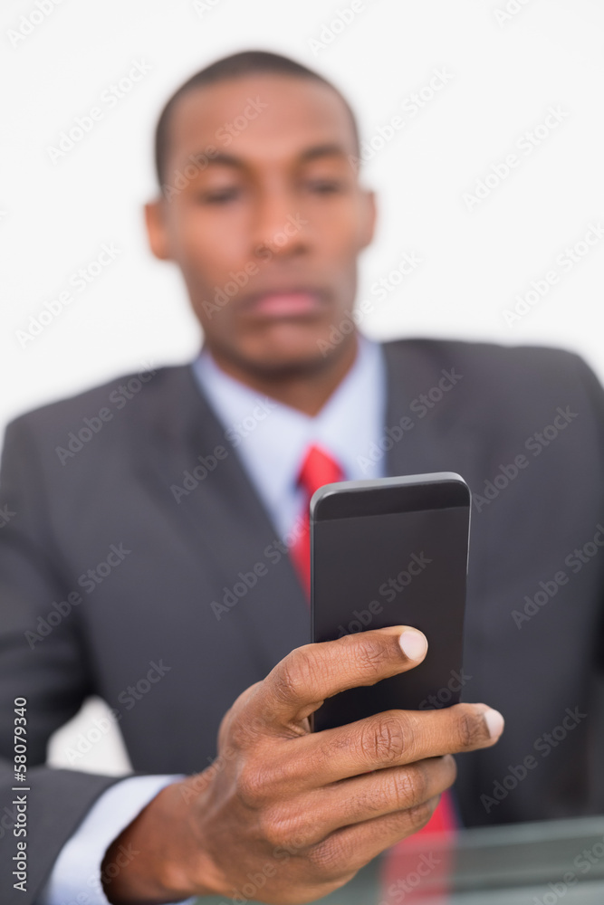 Portrait of an elegant young businessman text messaging Portrait of an elegant young businessman text messaging