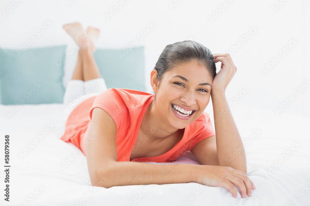 Cheerful young woman lying in bed Cheerful young woman lying in bed
