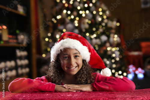 Girl with christmas hat on black