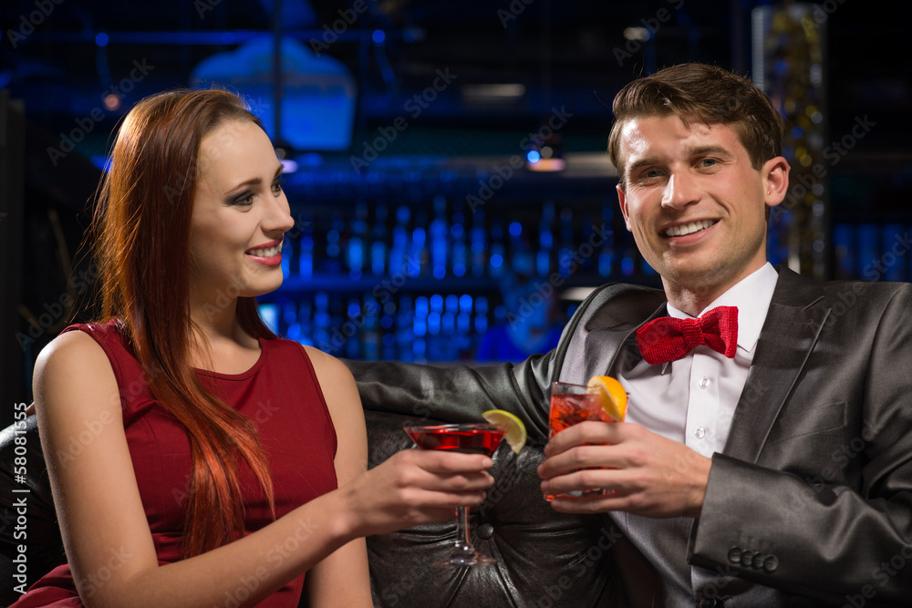 Young couple talking in a nightclub Young couple talking in a nightclub