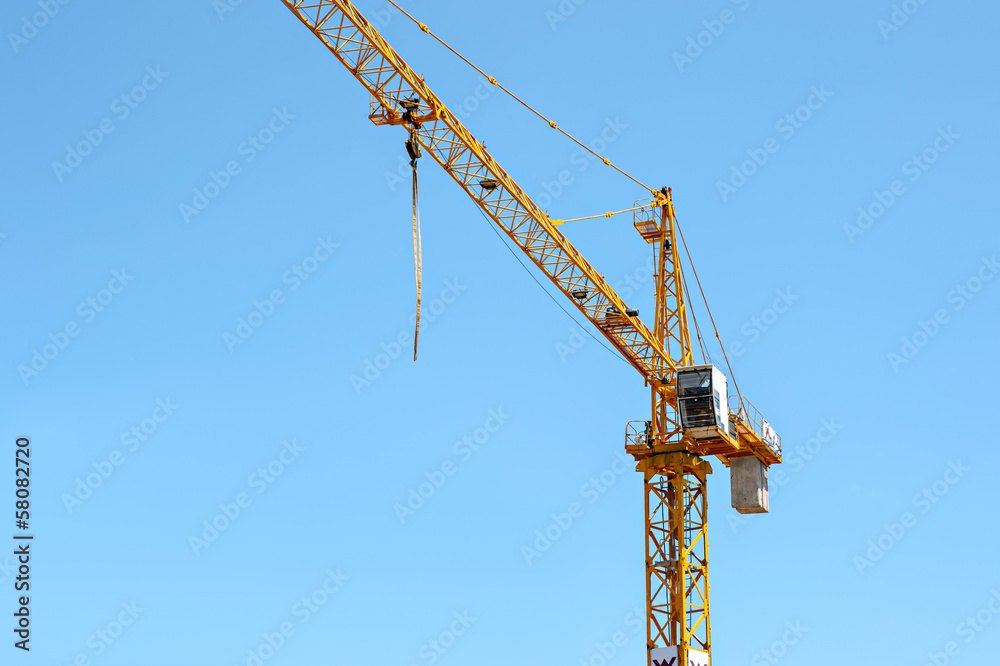 Construction crane against the blue sky Construction crane against the blue sky