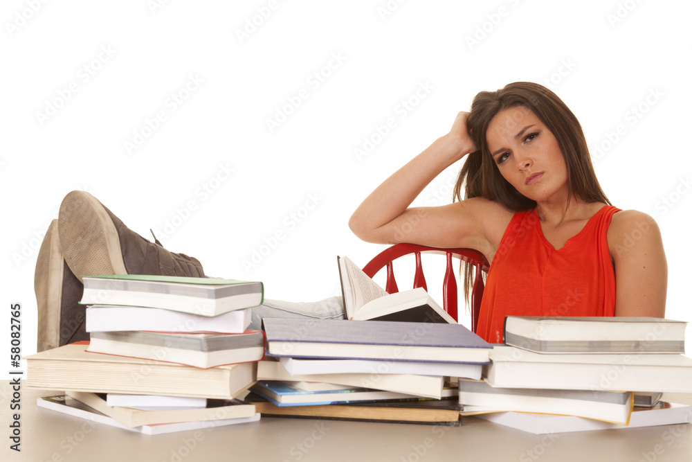 Woman red shirt lots of books serious