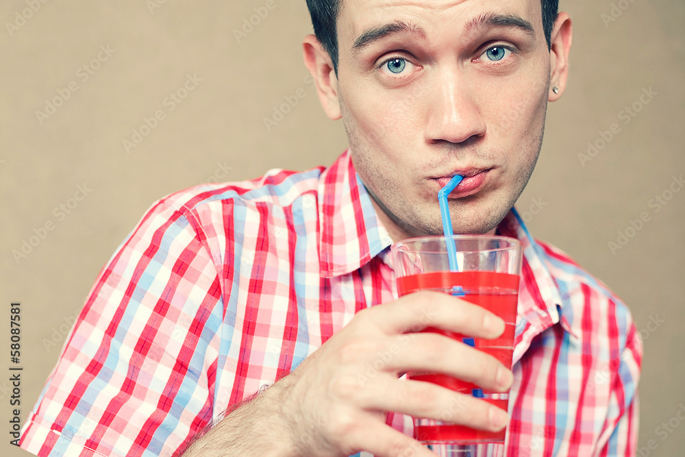 Confused thoughtful blue-eyed hipster boy drinking Confused thoughtful blue-eyed hipster boy drinking