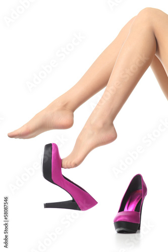 Beautiful woman legs with high heels dangling undressing