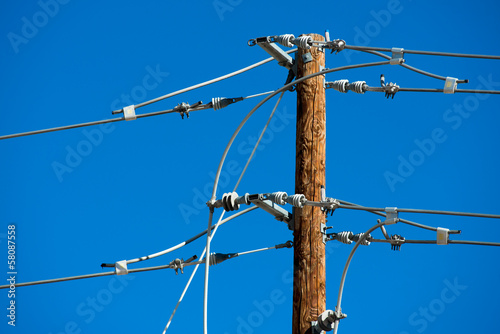 Detailed image of power lines and connections on a wooden post