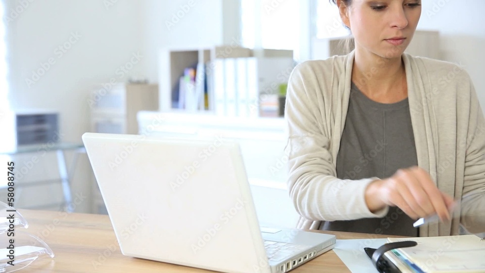 Attractive woman working in office on laptop Attractive woman working in office on laptop