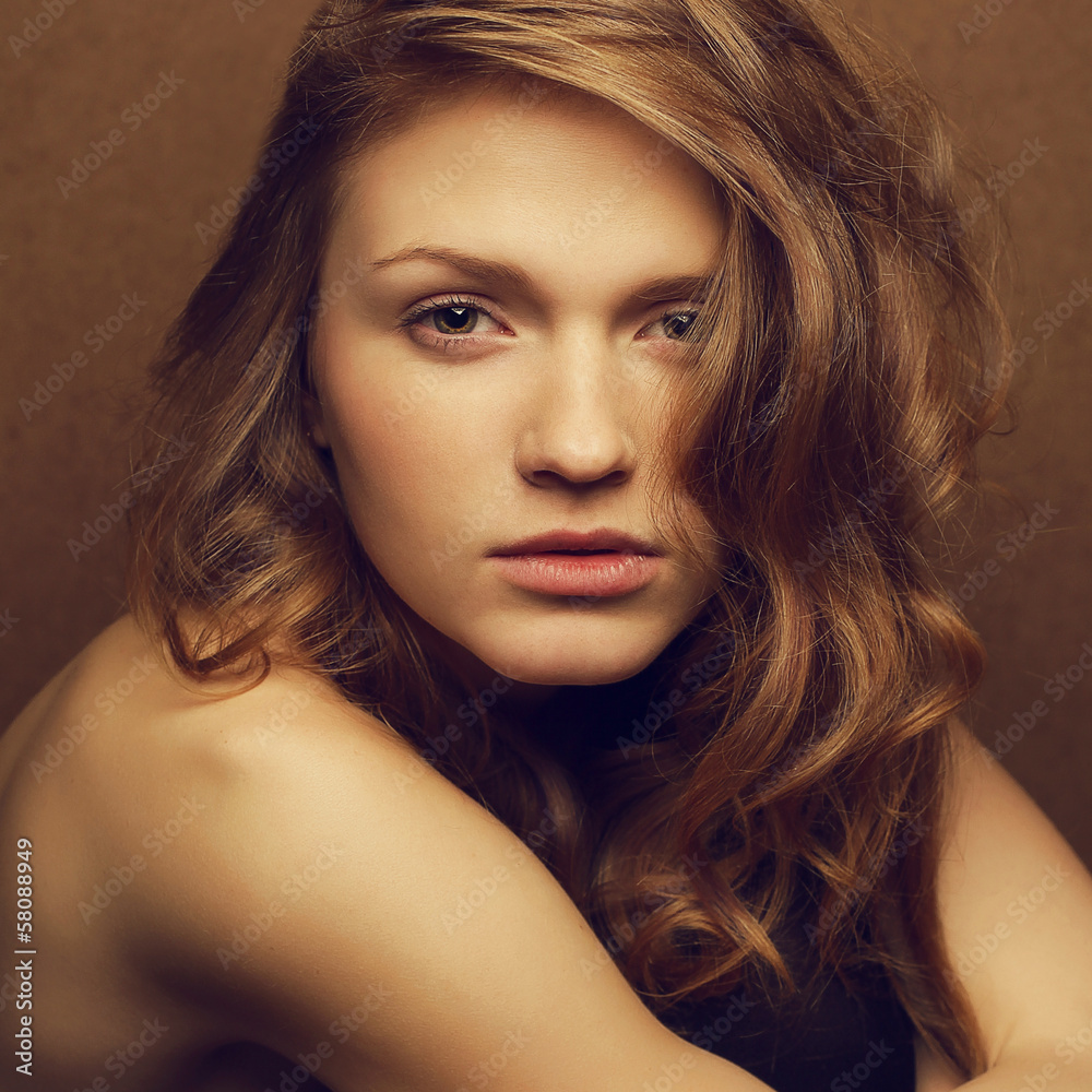 Fototapeta premium Emotive portrait of a young beautiful red-haired girl posing