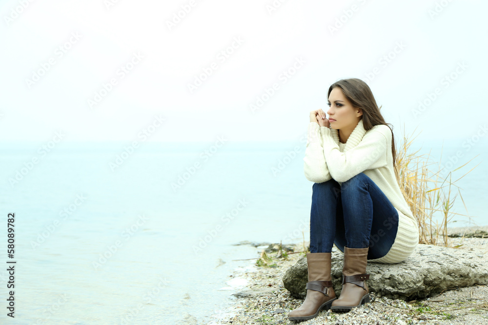 Portrait of young serious woman near river Portrait of young serious woman near river