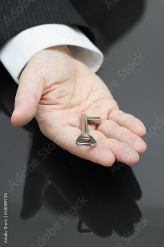 businessman holding the key to success