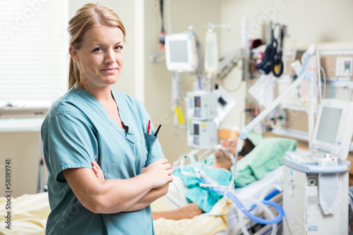 Confident Nurse With Patient Resting In Hospital