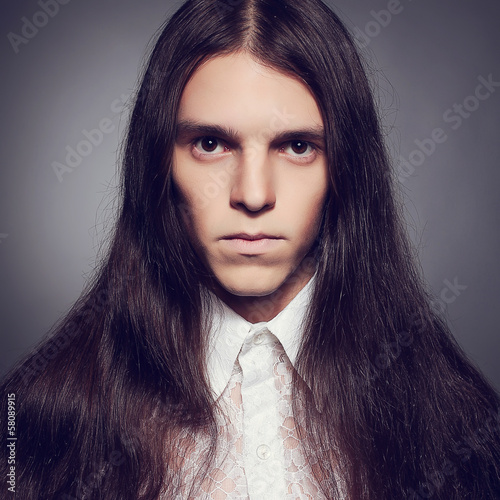 Old fashioned portrait of a long-haired young man