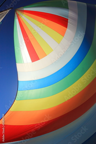 The wind has filled colorful spinnaker sail