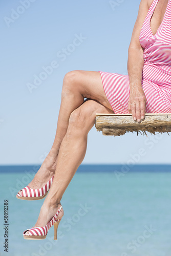 Woman sitting sexy leisure overlooking ocean