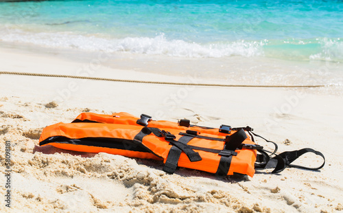 Orange life jacket on the beach