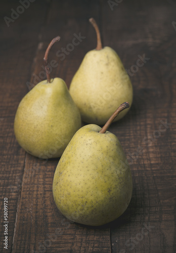 Pears on a rustic wooden kitchen table 