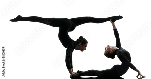 two women contortionist  exercising gymnastic yoga silhouette