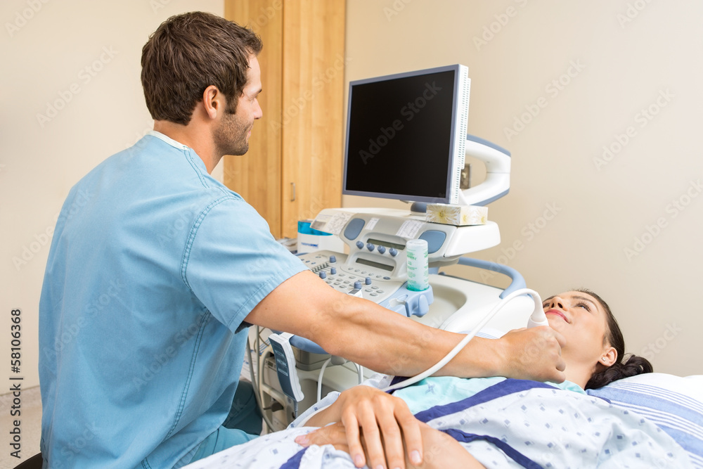 Male Nurse Performing Ultrasound On Patient's Neck Male Nurse Performing Ultrasound On Patient's Neck
