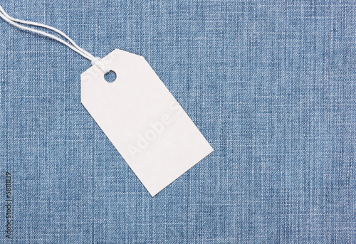 Blank paper label tag on blue jeans