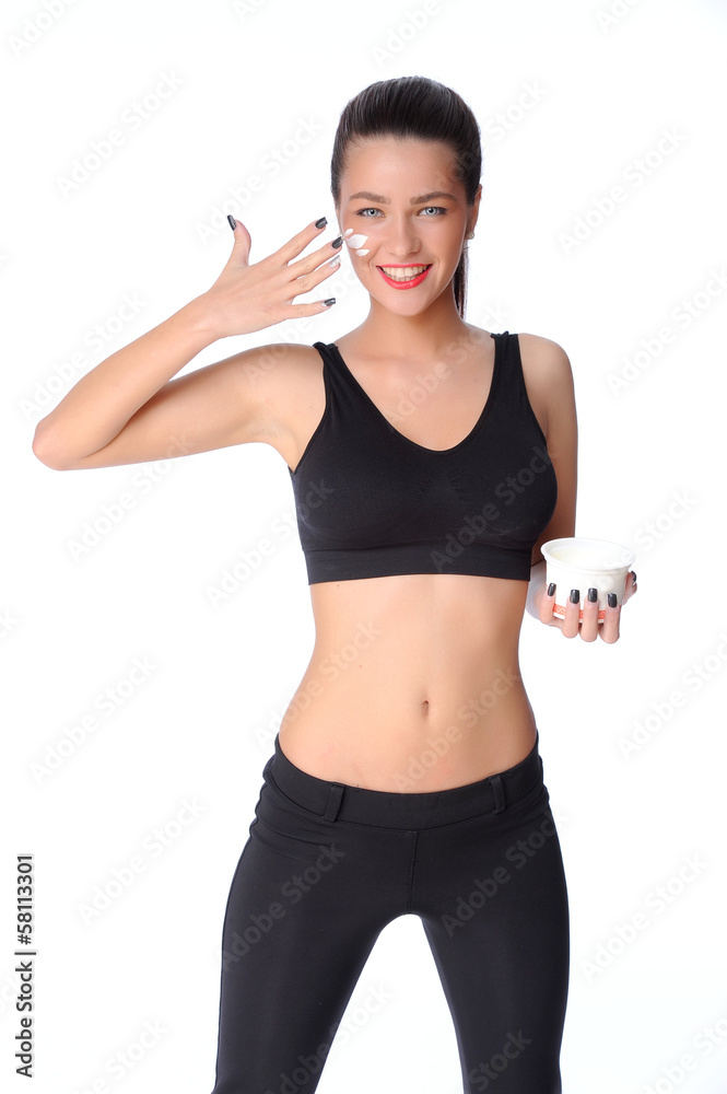 Beautiful face of young woman with cosmetic cream on a cheek Beautiful face of young woman with cosmetic cream on a cheek