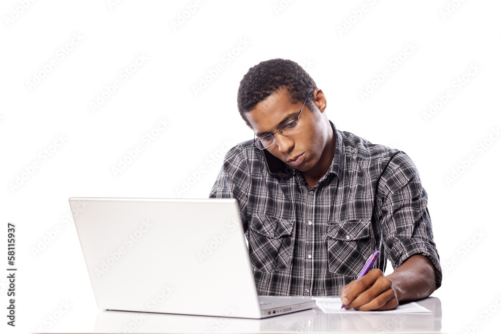 serious young black man writes data from his laptop serious young black man writes data from his laptop
