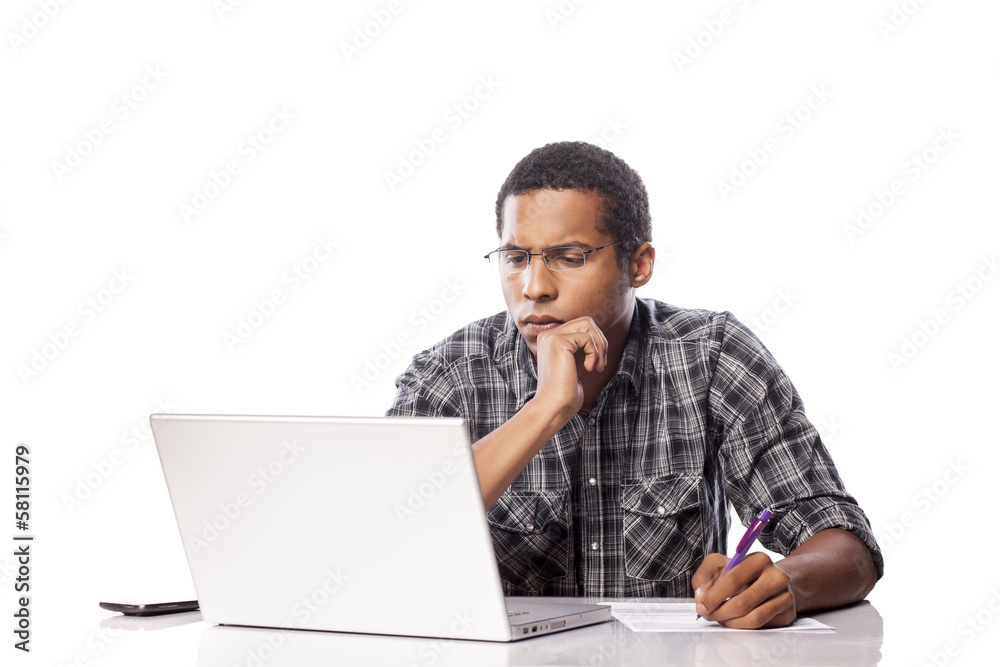 serious young black man writes data from his laptop serious young black man writes data from his laptop