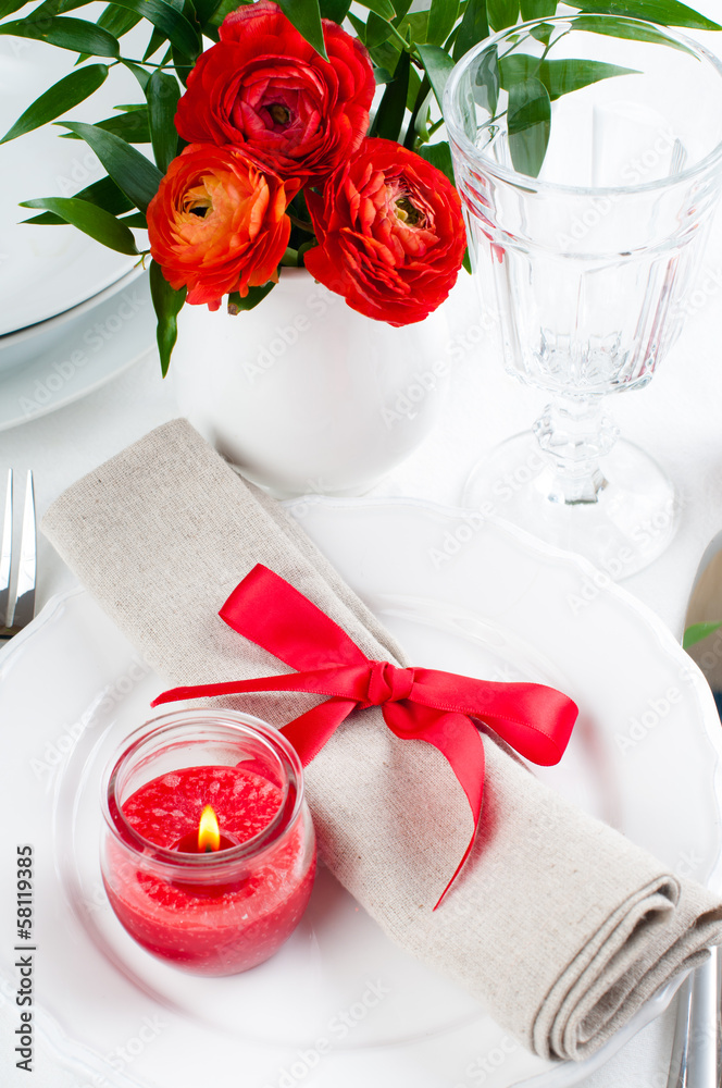 table setting with red flowers