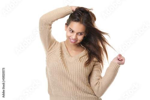 Cute girl smiling with hands in hair