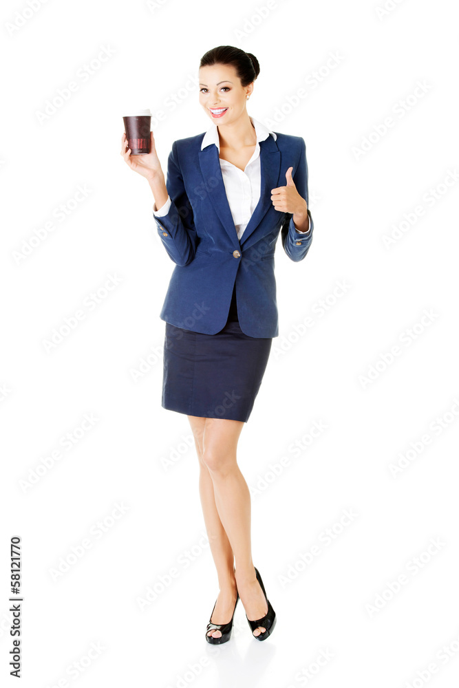 Attractive young business woman holding a cup and showing OK. Attractive young business woman holding a cup and showing OK.