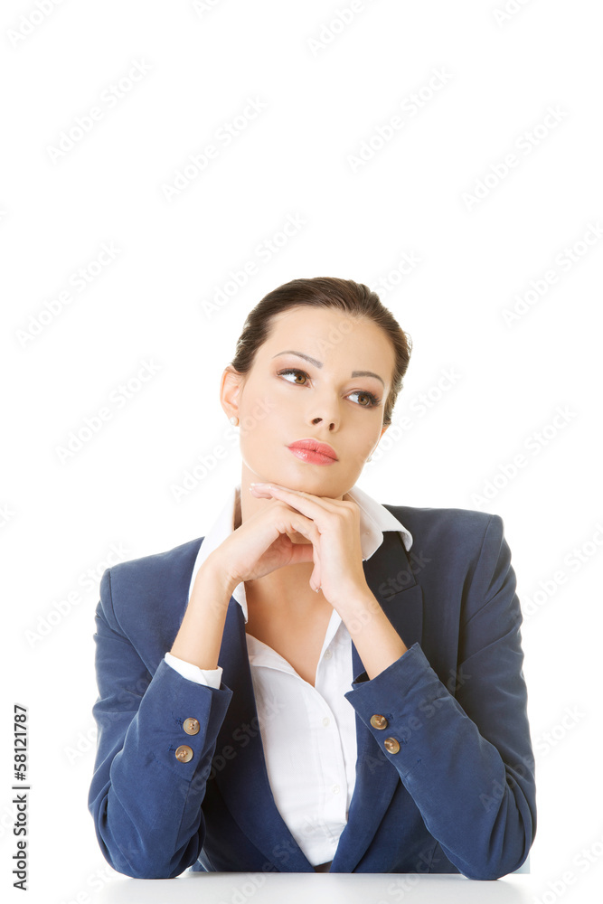 Attractive business woman proping her head, sitting. Attractive business woman proping her head, sitting.