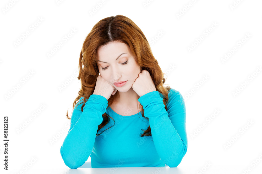Beautiful causal woman sitting with her head down. Beautiful causal woman sitting with her head down.