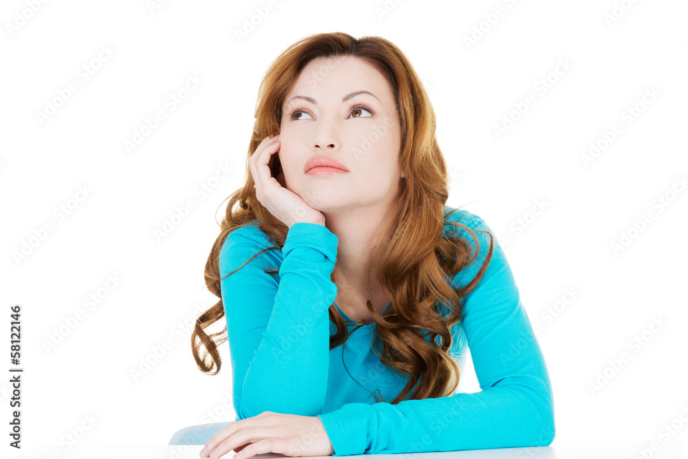 Attractive casual woman proping her head and looking up. Attractive casual woman proping her head and looking up.