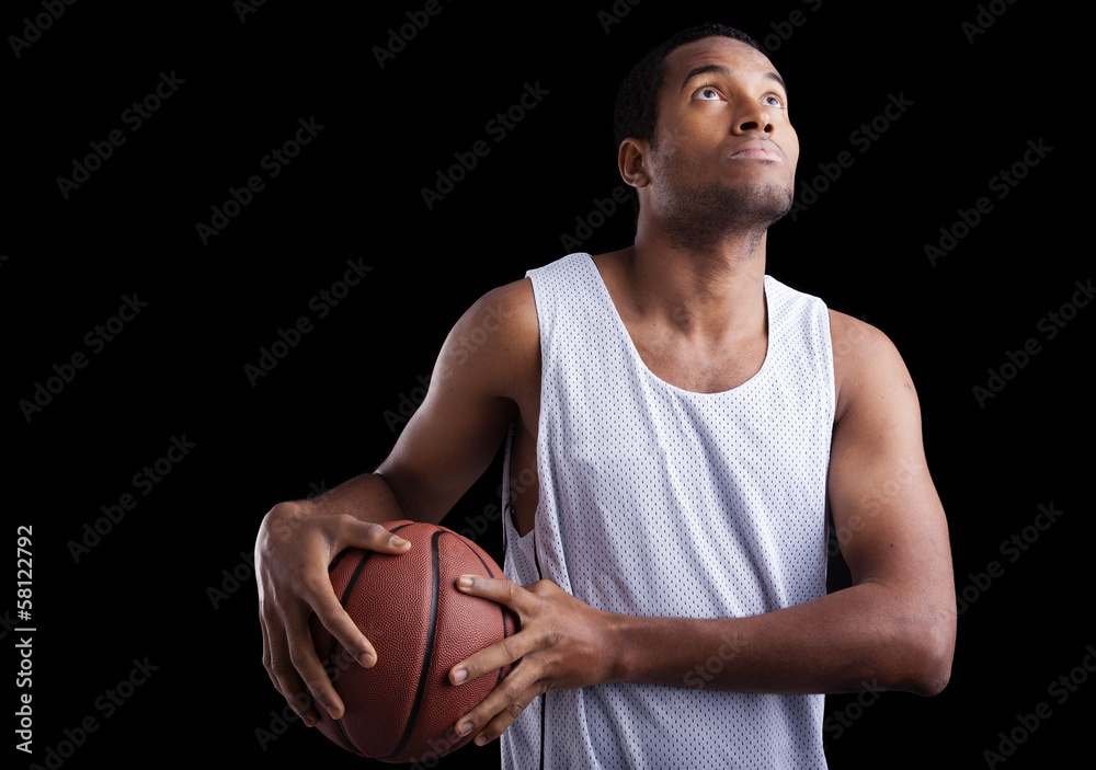 Basketball player with ball against dark background Basketball player with ball against dark background